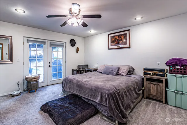 a bedroom with furniture and a flat screen tv