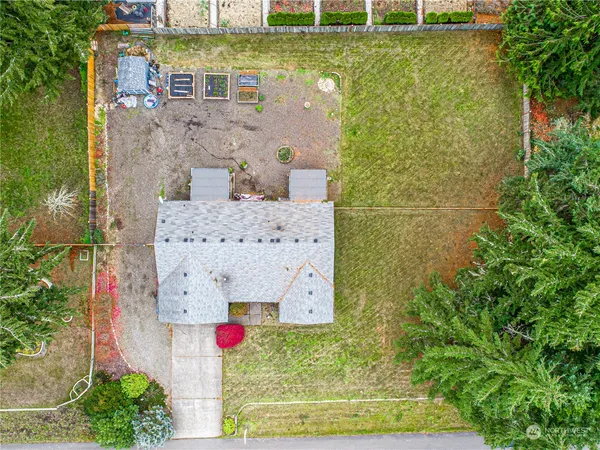 a aerial view of a house with pool and yard