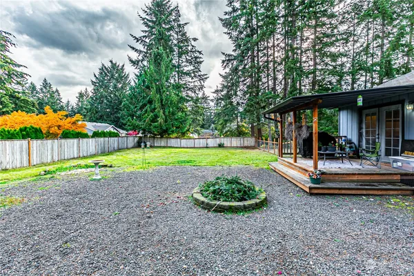 a view of a house with backyard and sitting area