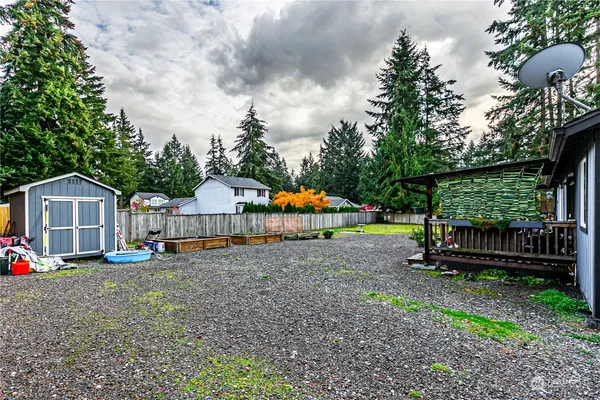 a view of a house with a yard and sitting area