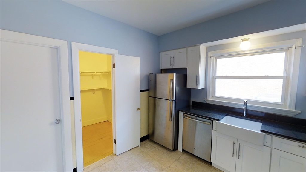 18 Murdock Street, Unit 1 Somerville, MA 02145 - Photo 3 of 10 a kitchen with a refrigerator and a sink