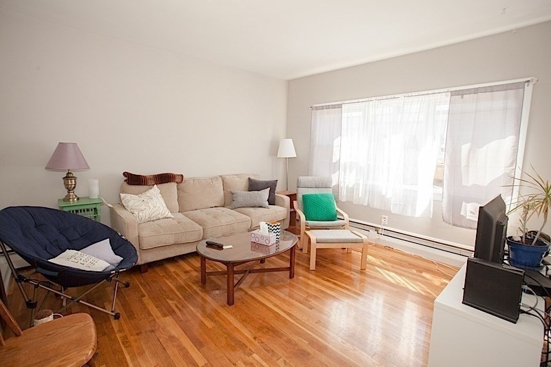 18 Murdock Street, Unit 1 Somerville, MA 02145 - Photo 4 of 10 a living room with furniture and a wooden floor