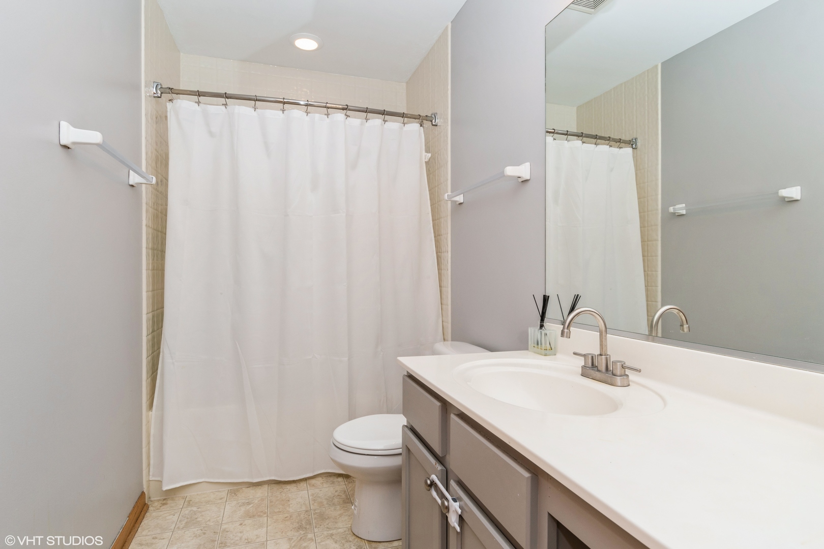 237 Springbrook Trail South, Unit 3 Oswego, IL 60543 - Photo 12 of 17 a bathroom with a sink a toilet and shower curtain