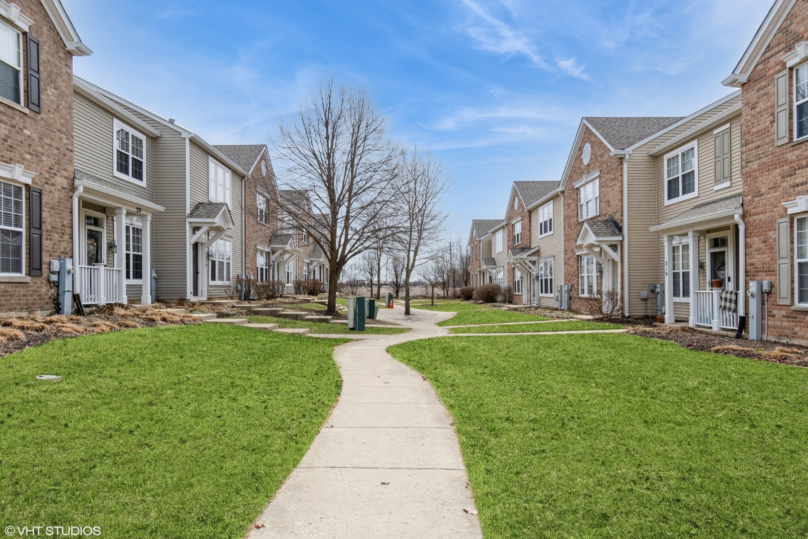 237 Springbrook Trail South, Unit 3 Oswego, IL 60543 - Photo 15 of 17 a view of a building with a yard