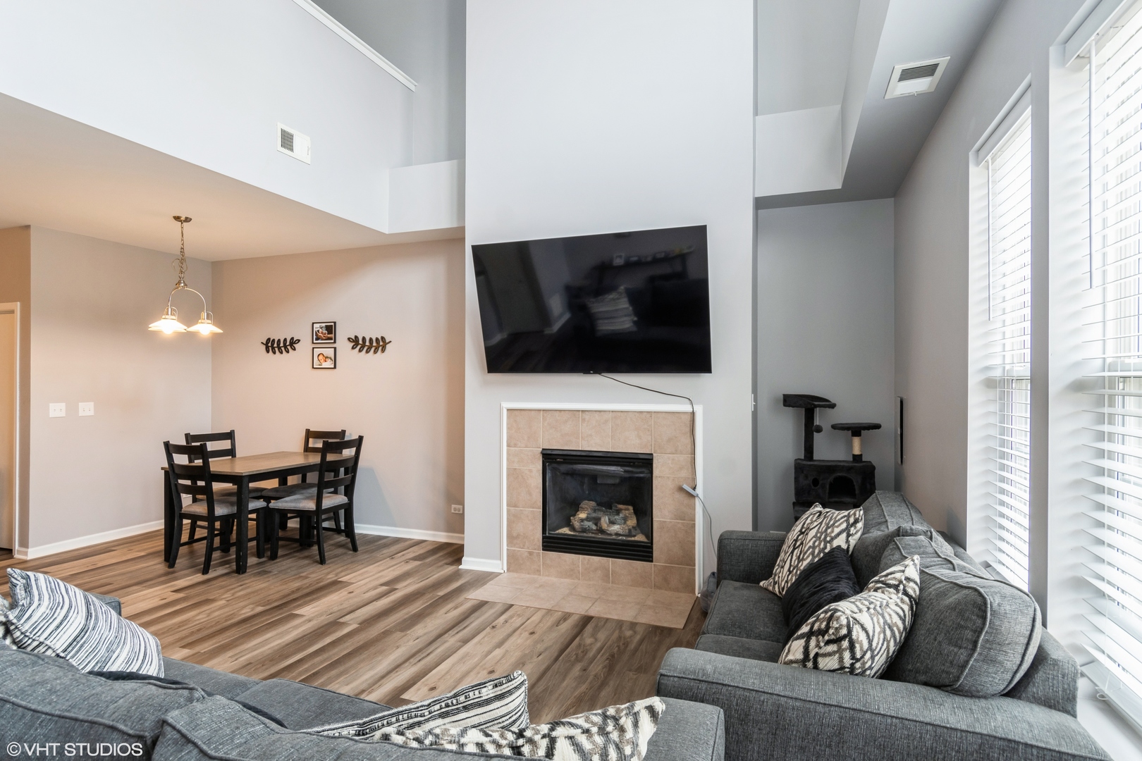 237 Springbrook Trail South, Unit 3 Oswego, IL 60543 - Photo 2 of 17 a living room with furniture a fireplace and a flat screen tv