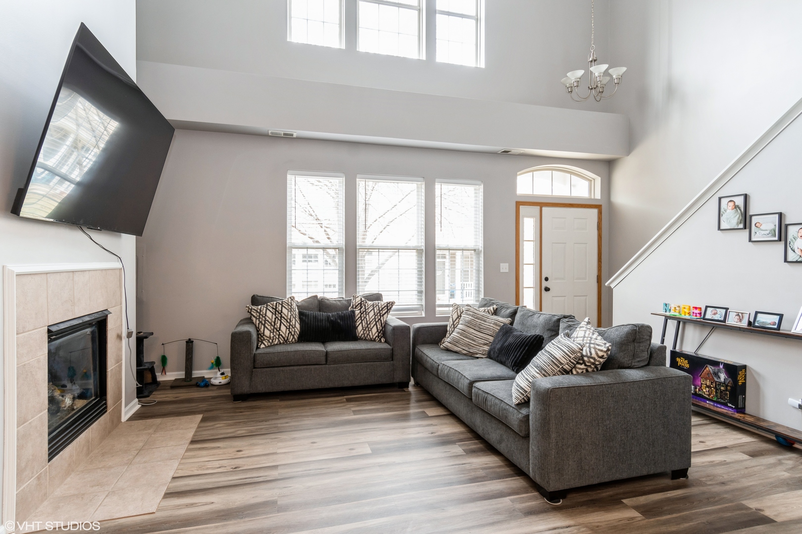237 Springbrook Trail South, Unit 3 Oswego, IL 60543 - Photo 4 of 17 a living room with furniture a flat screen tv and a fireplace