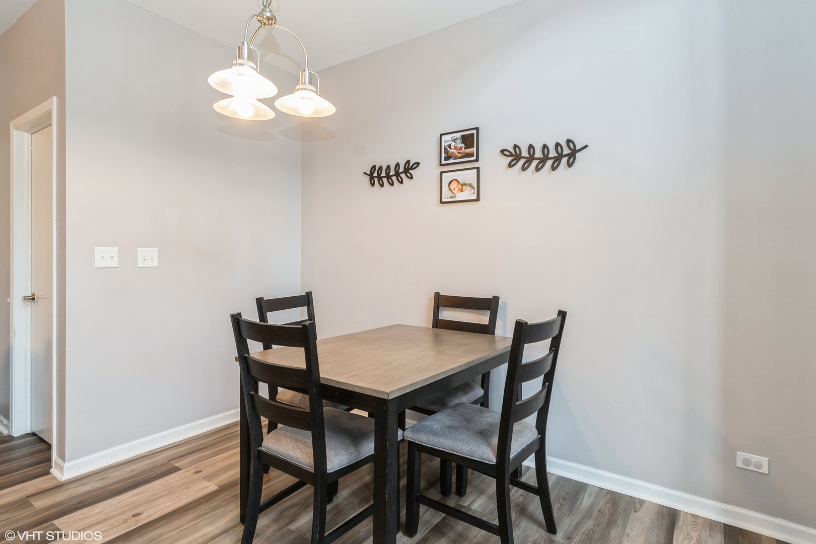237 Springbrook Trail South, Unit 3 Oswego, IL 60543 - Photo 7 of 17 a view of a dining room with furniture and wooden floor