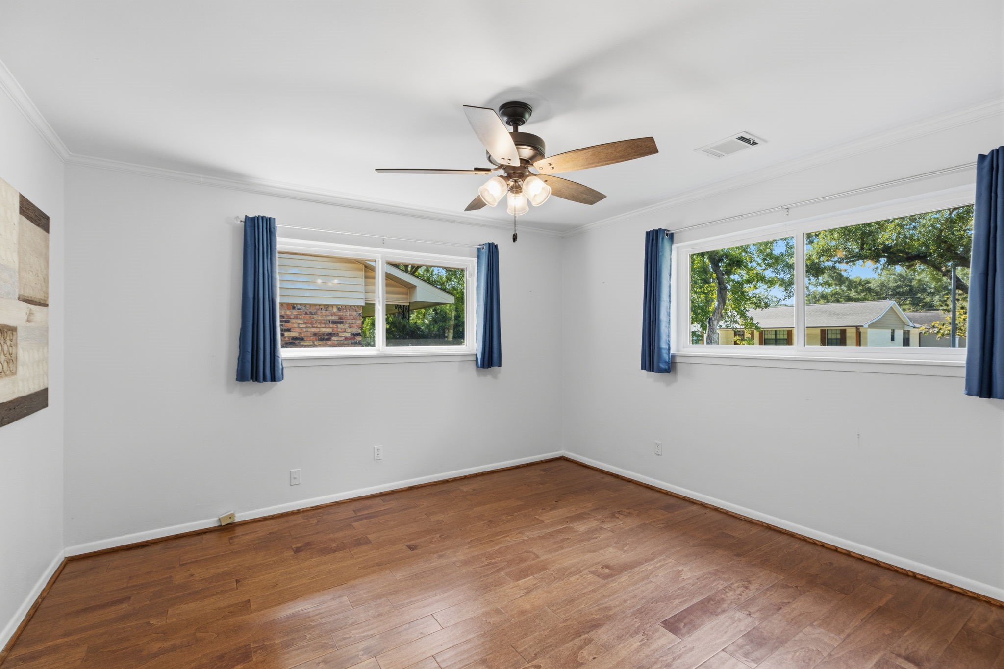 5410 Indigo Street Houston, TX 77096 - Photo 21 of 30 Another large secondary bedroom has double pane windows, gleaming floor, new ceiling fan and fresh paint.