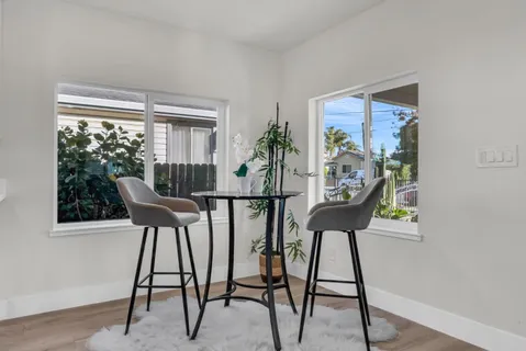 a kitchen with granite countertop kitchen island stainless steel appliances a stove a sink a refrigerator and chairs