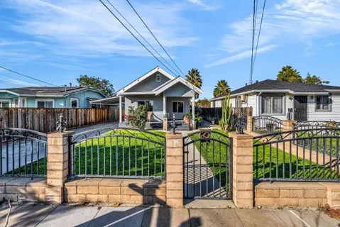 a front view of a house with a yard table and chairs