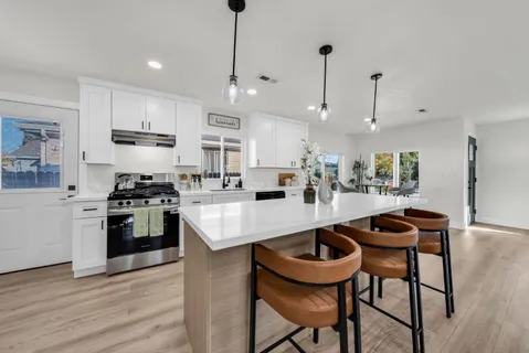 a view of an empty room with wooden floor and closet