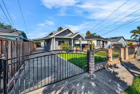 a view of a house with a yard and table