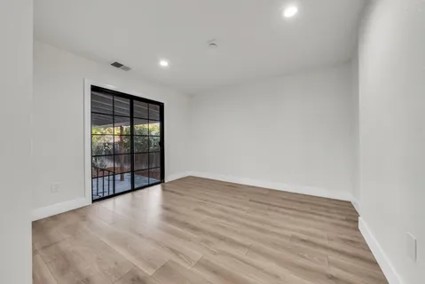 a living room with furniture a rug and a window