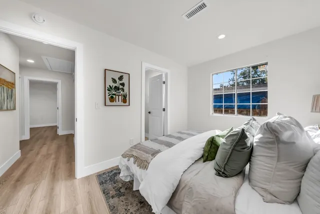 a view of a patio with table and chairs and wooden fence