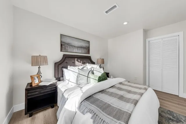 a view of backyard of house with wooden fence