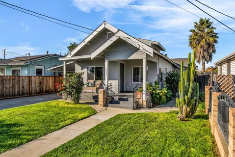 a living room with furniture and view of kitchen
