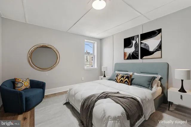 a bedroom with a large bed and a painting on the wall