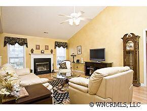 231 Farm Valley Road Fletcher, NC 28732 - Photo 2 of 12 a living room with furniture a fireplace and a flat screen tv