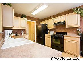 231 Farm Valley Road Fletcher, NC 28732 - Photo 4 of 12 a kitchen with a refrigerator stove and sink