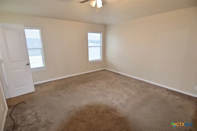 an empty room with windows and closet