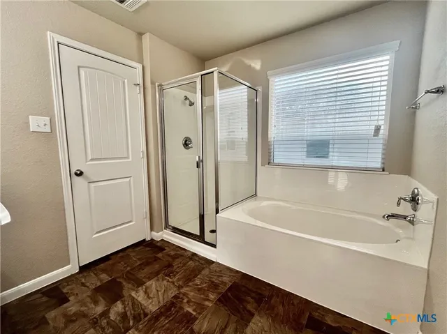 a bathroom with a bathtub and a shower