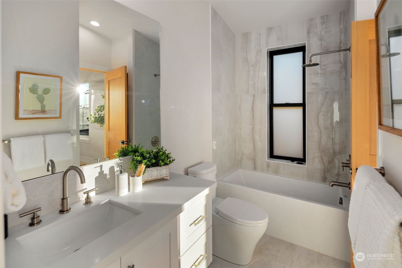 6601 39th Avenue Southwest Seattle, WA 98136 - Photo 14 of 40 a bathroom with a granite countertop sink and a large mirror
