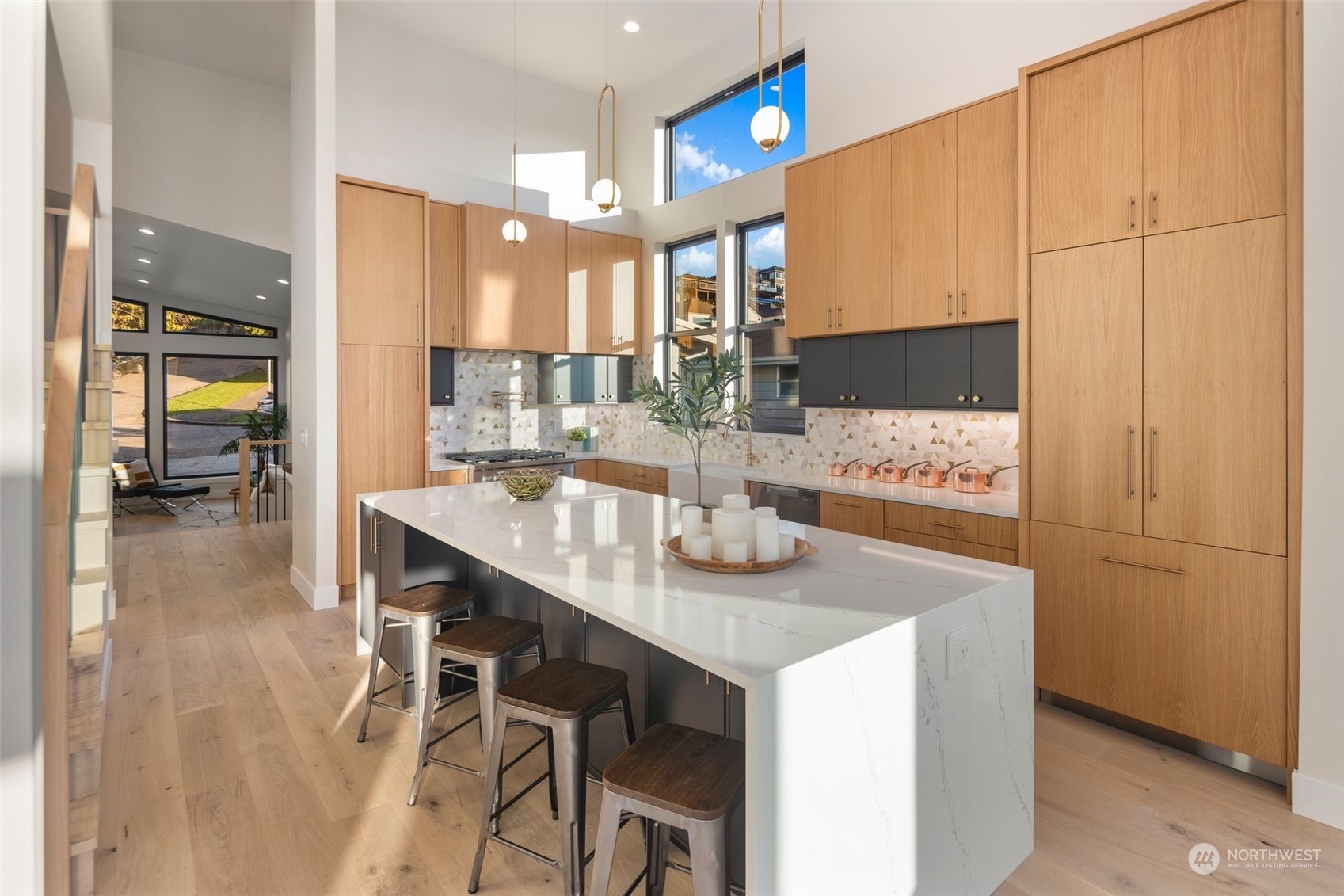 6601 39th Avenue Southwest Seattle, WA 98136 - Photo 4 of 40 a kitchen with kitchen island granite countertop a table chairs sink and cabinets