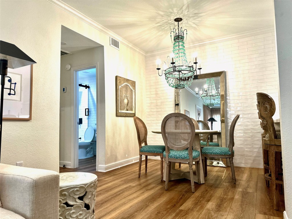 2001 Bering Drive, Unit 7L Houston, TX 77057 - Photo 20 of 33 a view of a dining room with furniture and chandelier