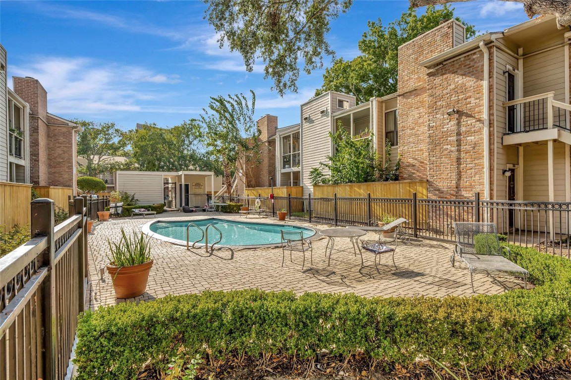 2001 Bering Drive, Unit 7L Houston, TX 77057 - Photo 31 of 33 a view of a swimming pool with a patio