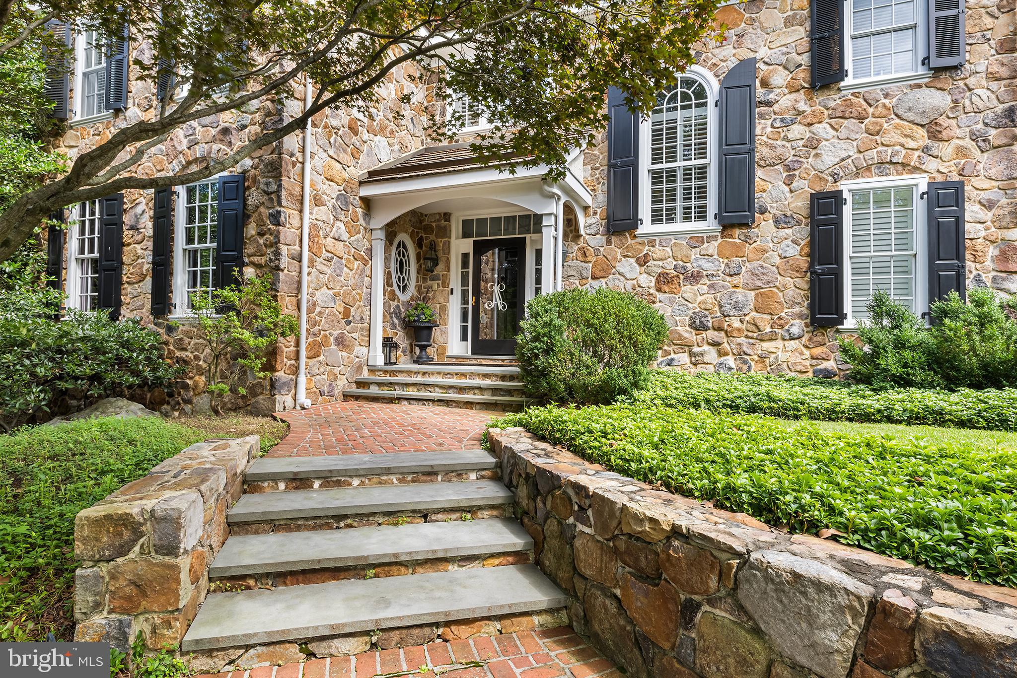 1278 Farm Road Berwyn, PA 19312 - Photo 2 of 65 a view of a house with brick walls plants and large tree