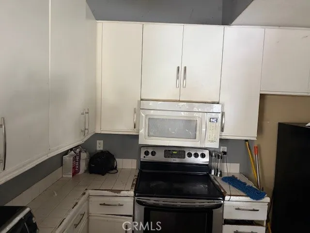 a kitchen with a stove and a refrigerator