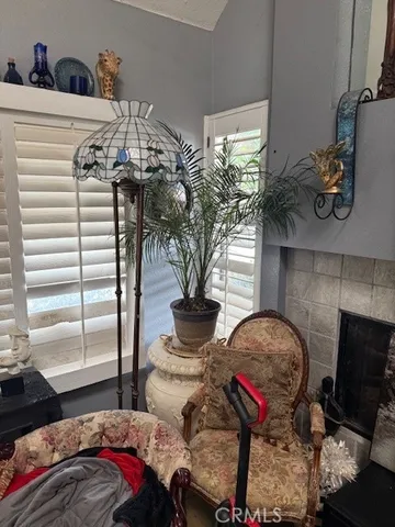a living room with furniture a fireplace and a chandelier