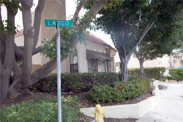 a view of a house with a tree in front of it