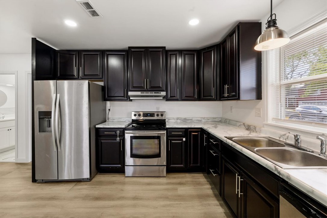 629 Little Meadow Drive Riverside, OH 45404 - Photo 17 of 48 This modern kitchen features sleek dark cabinetry, stainless steel appliances, and ample counter space.
