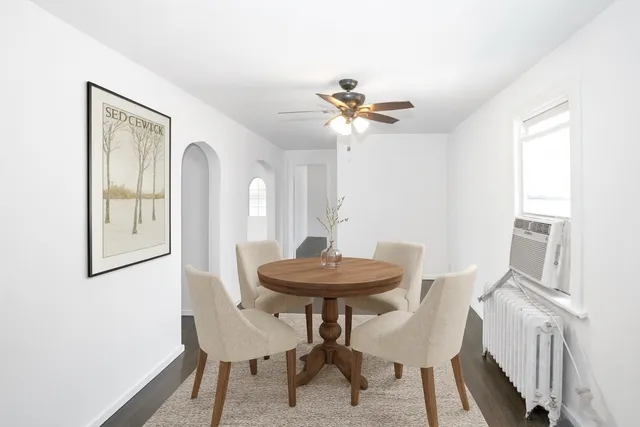a view of a dining room with furniture and a chandelier