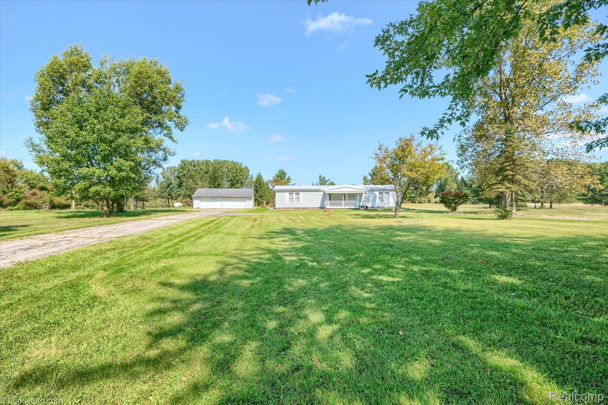 13566 Kaufman Road Capac, MI 48014 - Photo 48 of 50 View of grassy yard with driveway and a garage