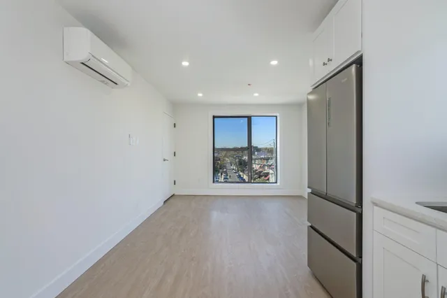 a kitchen with stainless steel appliances white cabinets and wooden floors