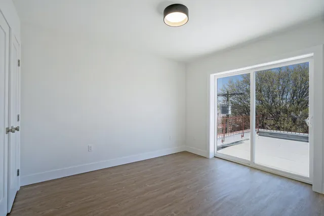 a view of a livingroom with wooden floor and window