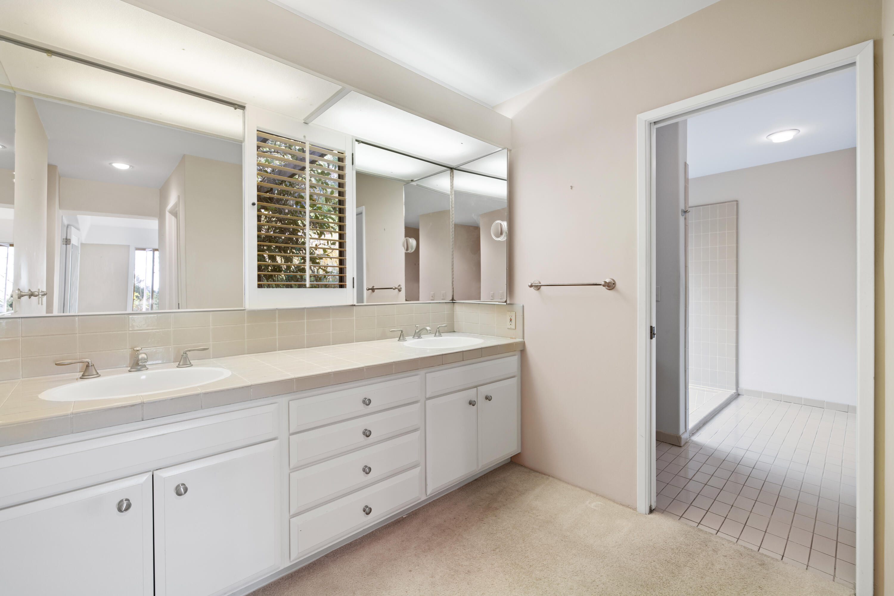 1986 Arriba Street Carpinteria, CA 93013 - Photo 14 of 28 a bathroom with double sink and a mirror