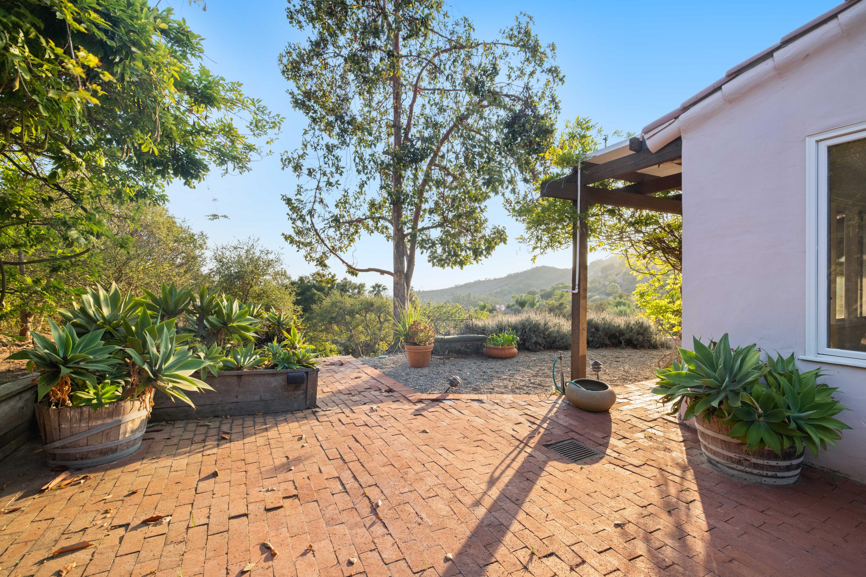 1986 Arriba Street Carpinteria, CA 93013 - Photo 27 of 28 a view of a backyard with couches and potted plants