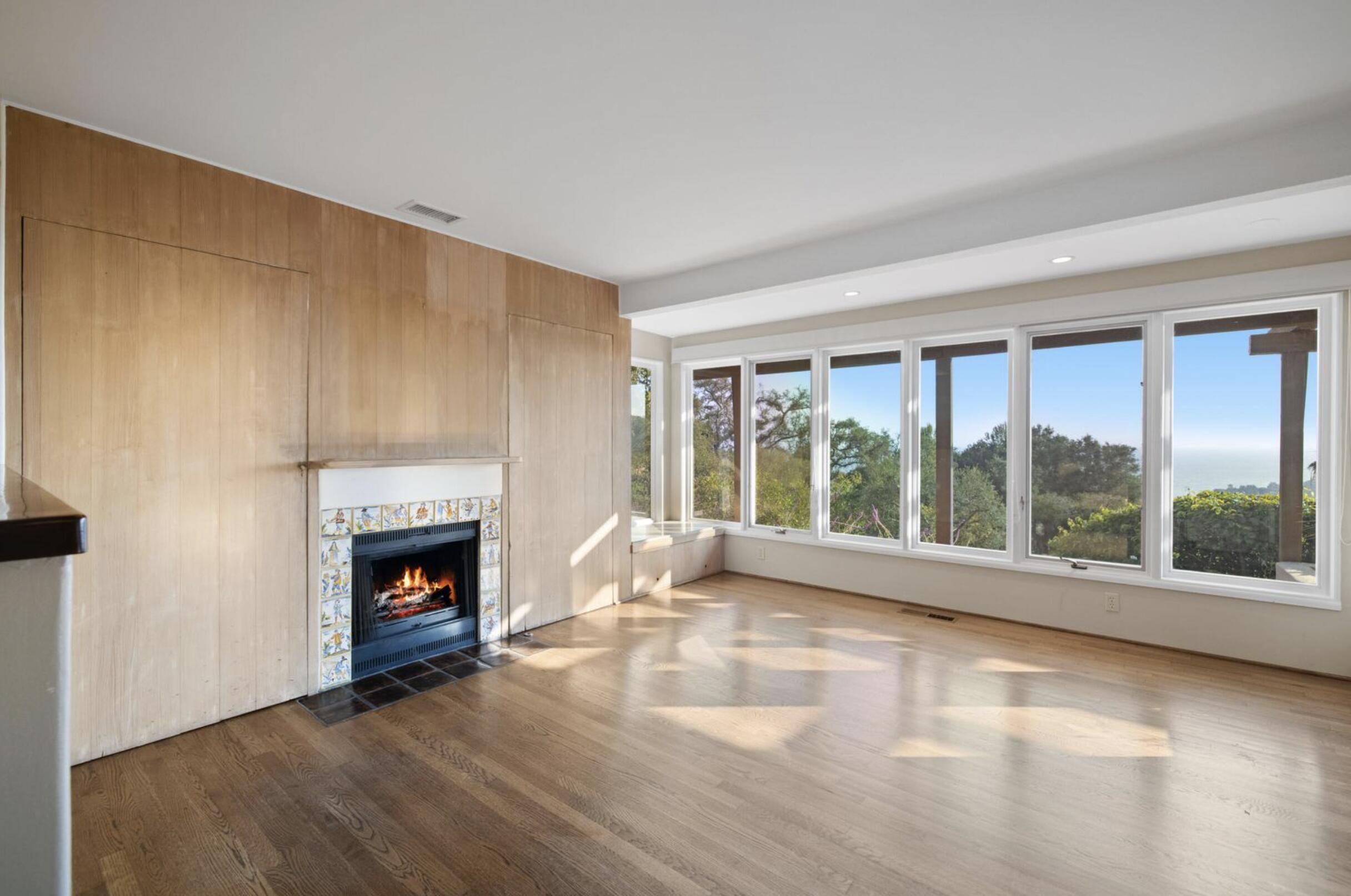 1986 Arriba Street Carpinteria, CA 93013 - Photo 10 of 28 a view of an empty room with a fireplace and a window