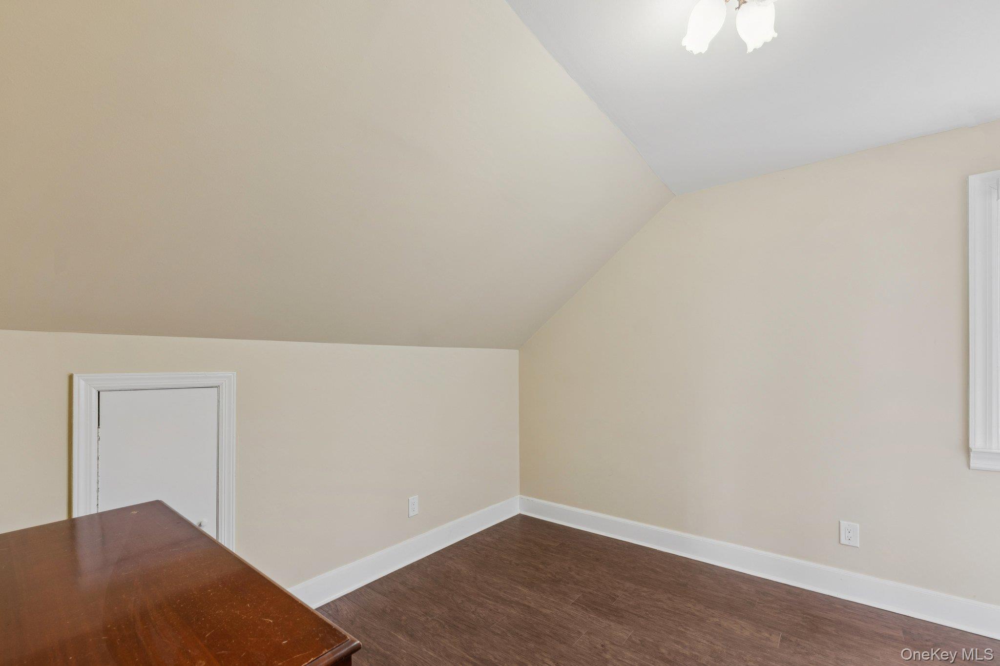 397 Split Rock Road Syosset, NY 11791 - Photo 21 of 29 an empty room with wooden floor