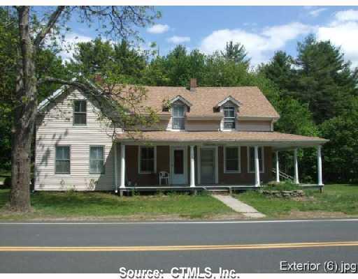 155 Monson Road Stafford, CT 06076 - Photo 1 of 1 a view of a white house with a garden and plants