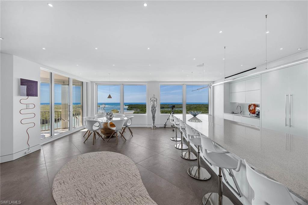 425 Dockside Drive, Unit 905 Naples, FL 34110 - Photo 12 of 50 a living room with furniture and a large window