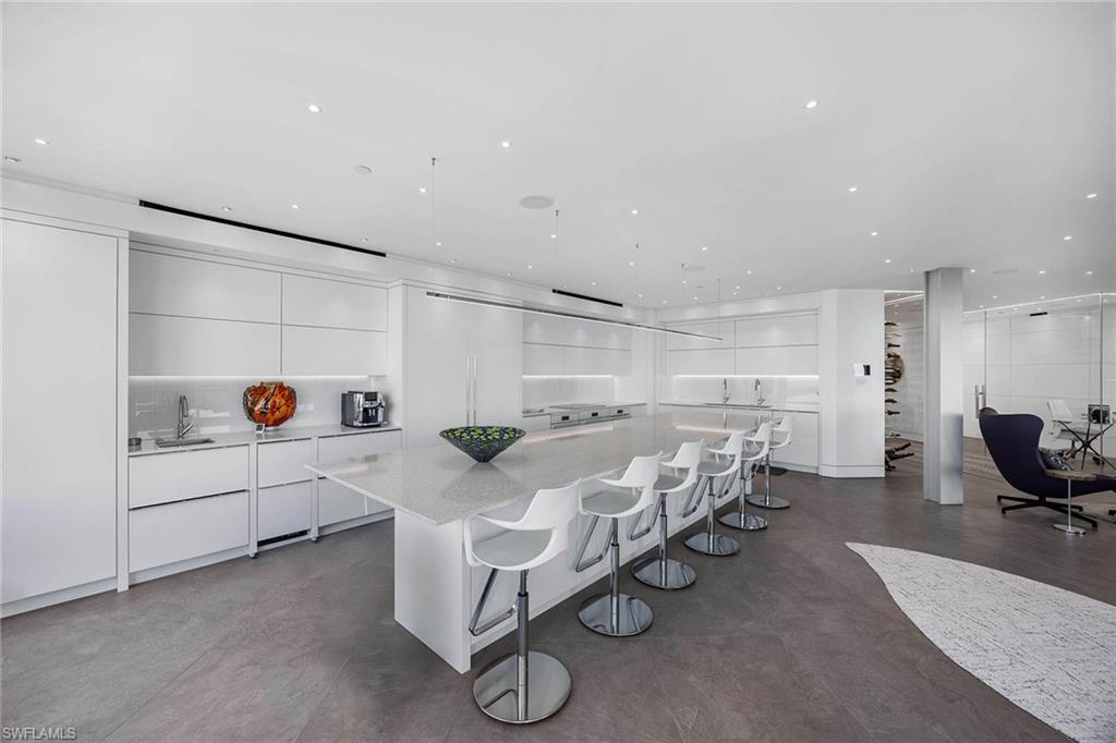 425 Dockside Drive, Unit 905 Naples, FL 34110 - Photo 15 of 50 a room with a bed and furniture