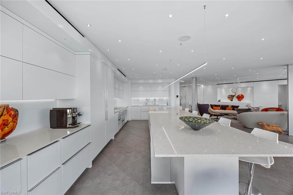 425 Dockside Drive, Unit 905 Naples, FL 34110 - Photo 16 of 50 a kitchen with stainless steel appliances a stove a sink dishwasher and a refrigerator with white cabinets