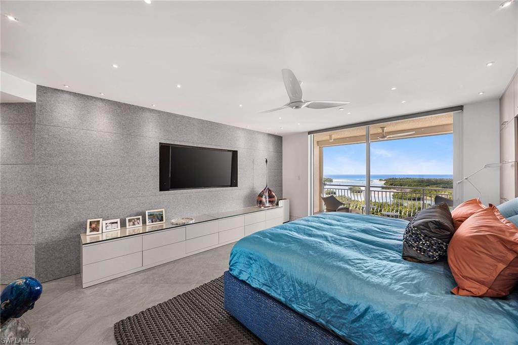 425 Dockside Drive, Unit 905 Naples, FL 34110 - Photo 20 of 50 a spacious bedroom with a bed and a flat screen tv