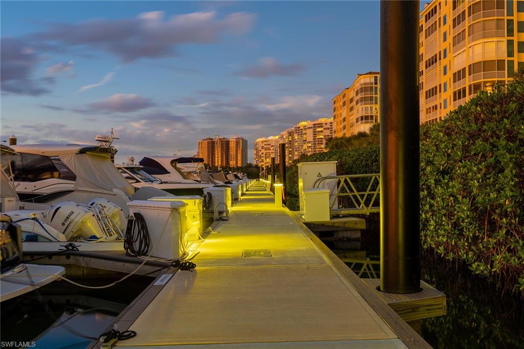 425 Dockside Drive, Unit 905 Naples, FL 34110 - Photo 42 of 50 a view of a swimming pool with sitting area