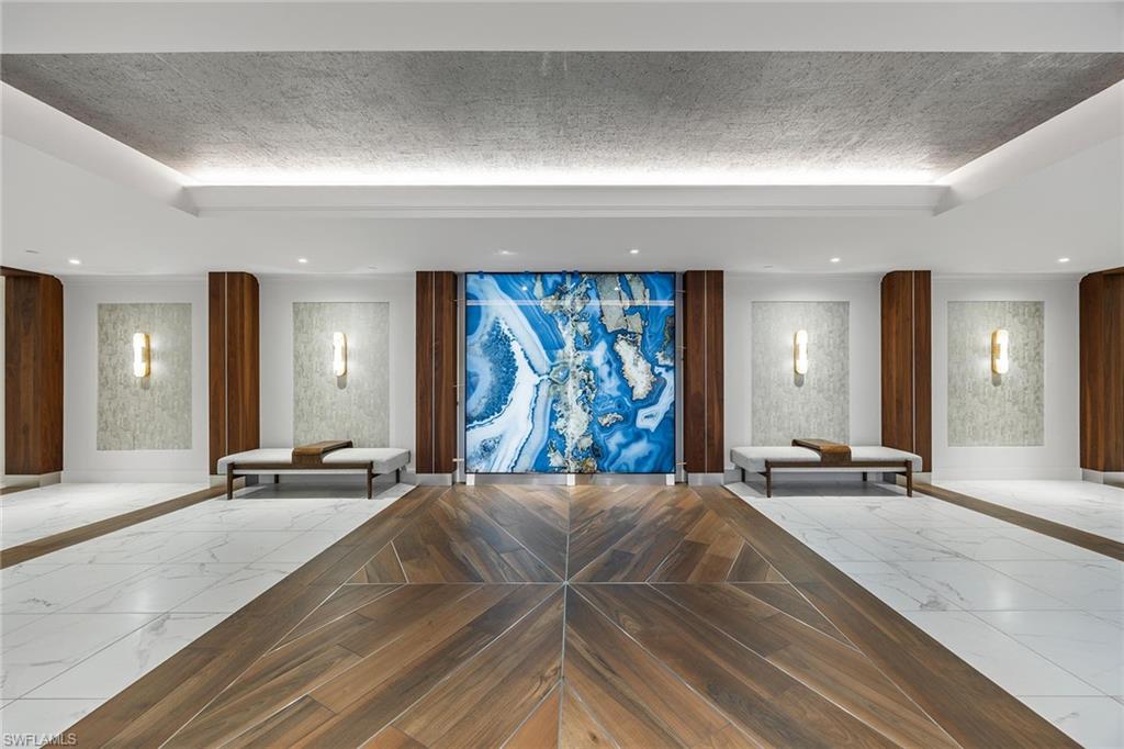 425 Dockside Drive, Unit 905 Naples, FL 34110 - Photo 43 of 50 a view of a hall with a couch