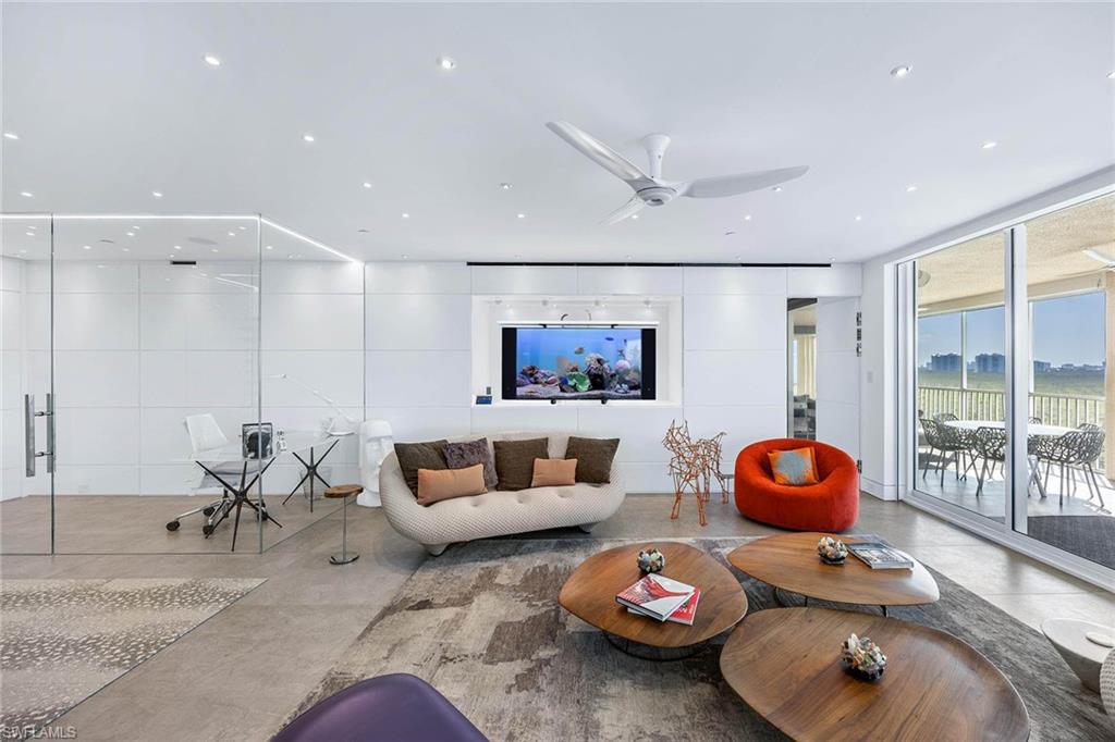 425 Dockside Drive, Unit 905 Naples, FL 34110 - Photo 44 of 50 a living room with furniture and a wooden floor